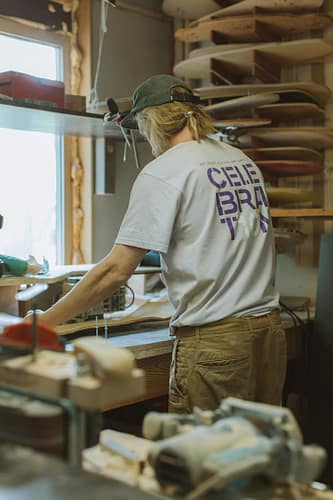 pexels photo 4888892 A craftsman skillfully shapes skateboards in a well-equipped workshop.